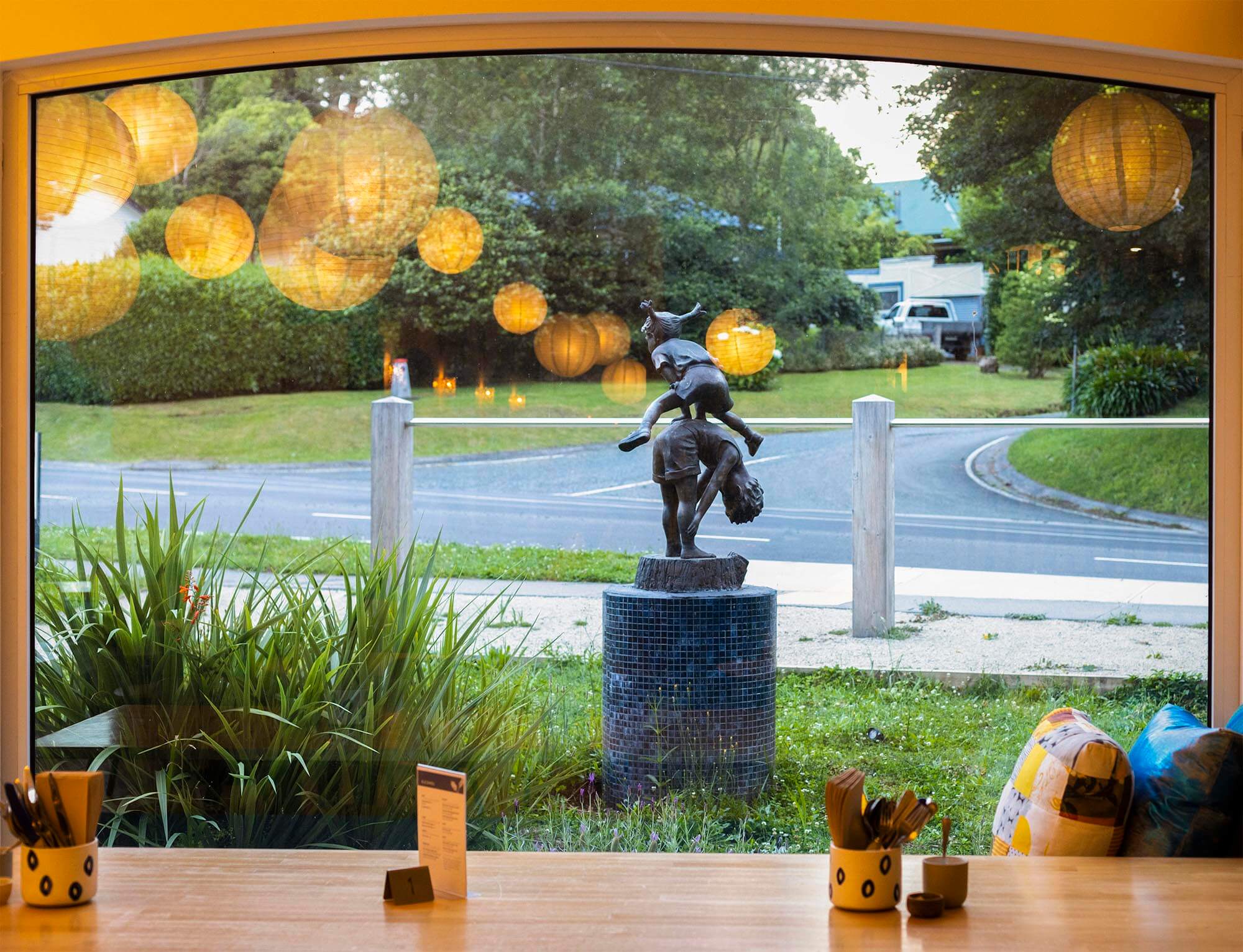 A Statue of two kids playing through the window at Proserpina